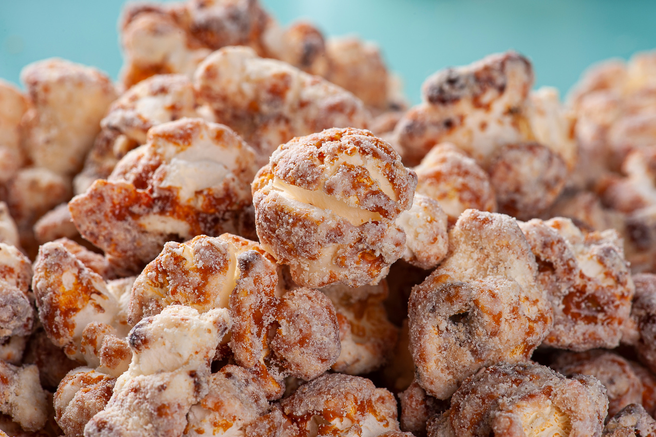 Gourmet sweet popcorn in plastic cup. Caramel flavor.